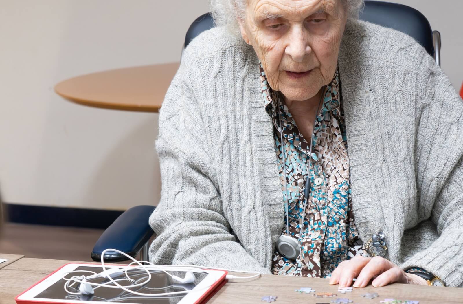 A senior doing a jigsaw puzzle.